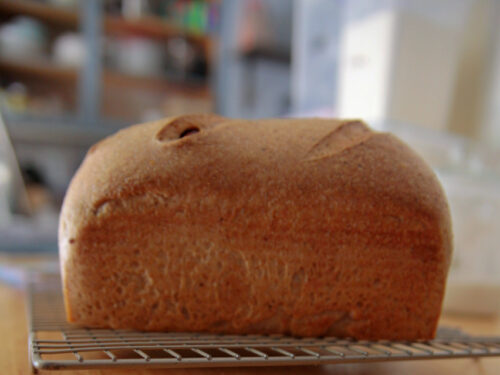 sourdough sandwich loaf cooling on the cooling rack.